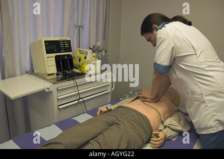 male nurse practicing life support chest compressions on a training doll Stock Photo