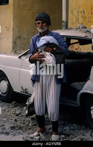 Elderly man with holding some belongings during the bombings if Beirut in the spring of 1989 Jdeideh area Stock Photo