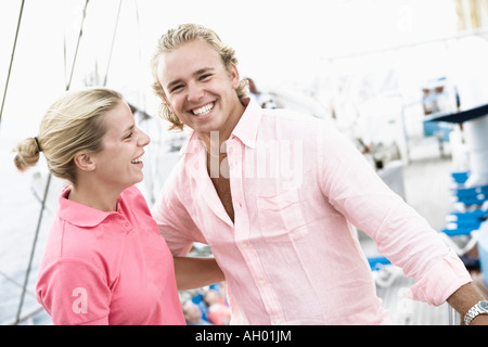 Young couple standing with their arms around each other and smiling Stock Photo