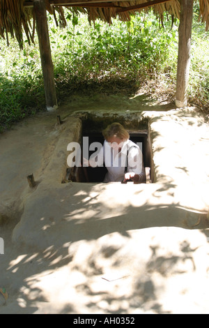 A woman  tourist leaving an exit of the Chu Chi tunnels Vietnam Stock Photo