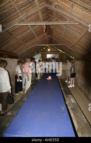 Group of tourists visiting a Chu Chi tunnel complex meeting room in Vietnam for the Viet Cong army Stock Photo