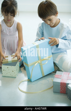Boy and girl opening presents Stock Photo