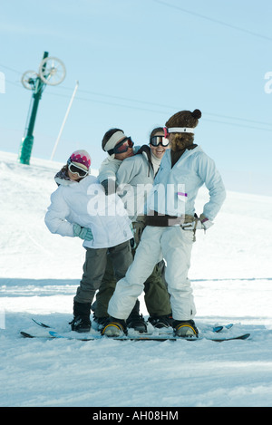 Group of snowboarders posing in snow, full length Stock Photo