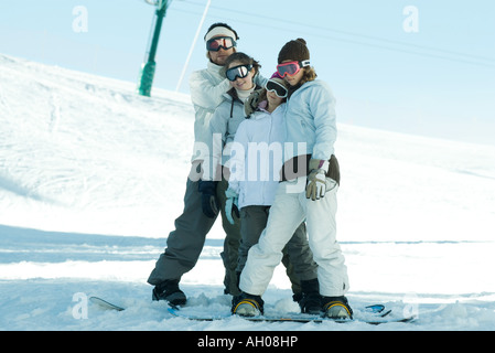 Group of snowboarders posing in snow, full length Stock Photo