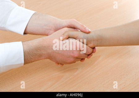 two handed hand shake by business man and woman Stock Photo