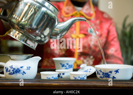 Woman serving tea, cropped view Stock Photo