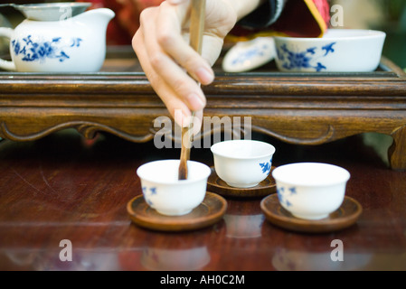 Woman preparing tea, cropped view of hand Stock Photo