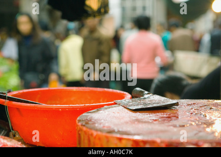 Meat cleaver on chopping block in market, close-up Stock Photo