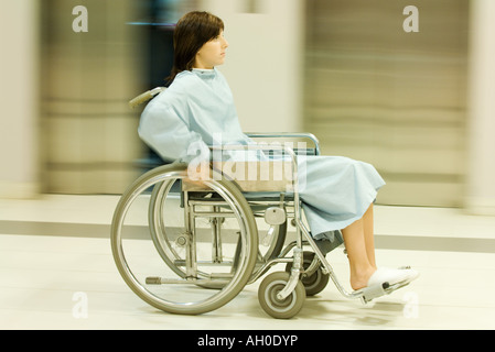 Woman using wheelchair, full length, blurred motion Stock Photo