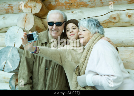 Teenage girl photographing self with grandparents Stock Photo