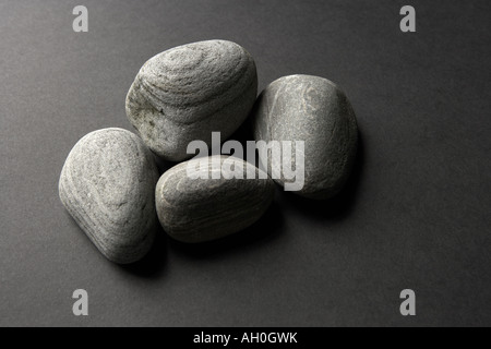 Pebbles on Grey background Stock Photo