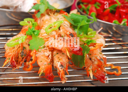 Barbecued skewered tiger prawns with chilli, garlic and coriander Stock Photo