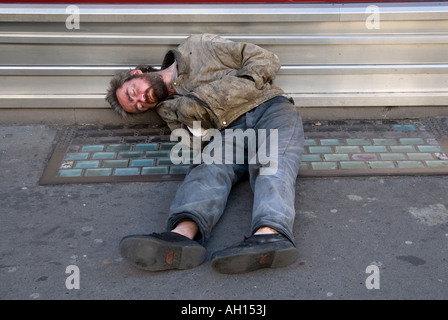 Homeless man sleeping on the street in central London England UK Stock Photo