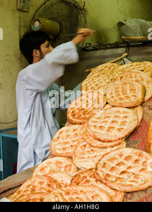 fresh nan coming out of the tandoor oven in Peshawar Pakistan Stock Photo