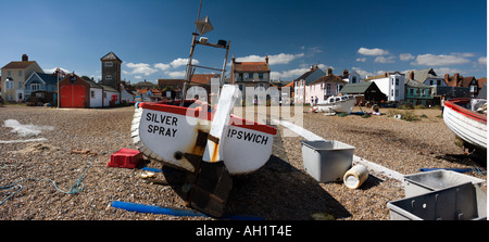 Quaint old fishing boats on the beach at Aldeburgh in Suffolk, WITH THE old rnli lifeboat station IN THE BACKGROUND Stock Photo