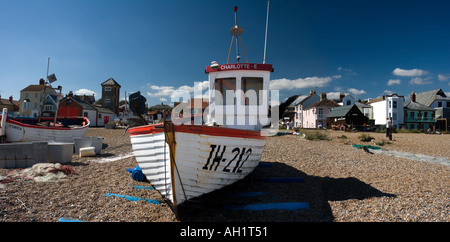 Quaint old fishing boats on the beach at Aldeburgh in Suffolk, WITH THE old rnli lifeboat station IN THE BACKGROUND Stock Photo