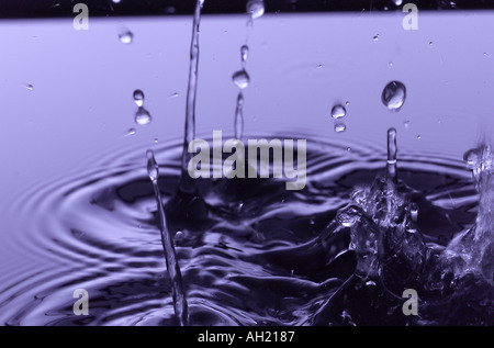 Water drops in calm water Stock Photo