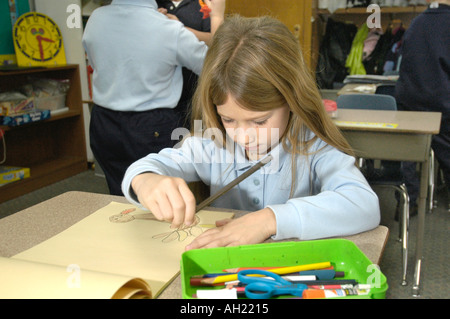Child student working alone on a project at Elementary School Stock Photo