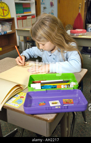 Child student working alone on a project at Elementary School Stock Photo