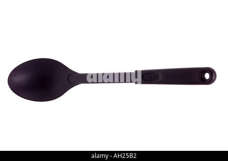 big plastic cooking spoon silhouetted on white background Stock Photo