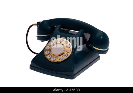 replica green and gold telephone silhouetted on white background Stock Photo