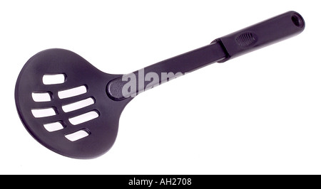 slotted cooking spoon silhouetted on white background Stock Photo