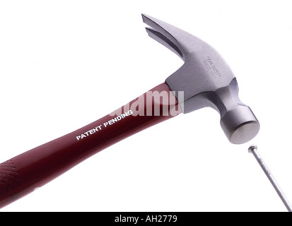 hammer striking a nail silhouetted on white background Stock Photo