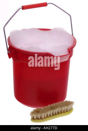 Red bucket of sudsy water and scrub brush silhouetted on white background Stock Photo