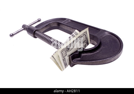 hundred dollar bill in a C clamp silhouetted on white background Stock Photo