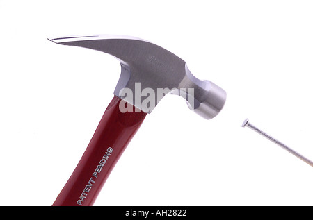 hammer hitting nail silhouetted on white background Stock Photo