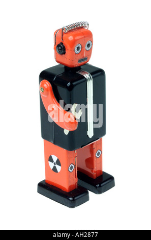 An antique toy metal robot silhouetted on white background Stock Photo