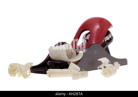 Carpenters' block plane with wood shavings, silhouetted on white background Stock Photo