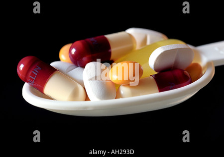 Variety of tablets, pills and capsules on a medicine spoon Stock Photo