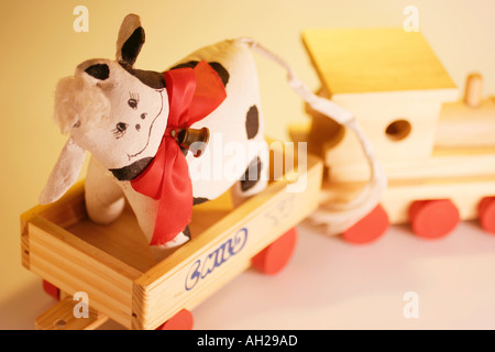Toy Cow on Wooden Train Stock Photo