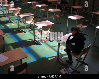 empty exam room with single candidate still working Stock Photo