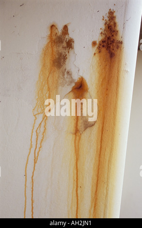 Part of park or seaside or transport shelter showing rust stains coming through reinforced concrete and making brown patterns Stock Photo