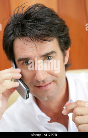 Businessman using mobile phone in a restaurant Stock Photo