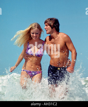 young couple running in surf Stock Photo