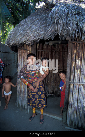 A portrait of a Kuna women standing outside her home on the San Blas Islands Panama with her baby Stock Photo