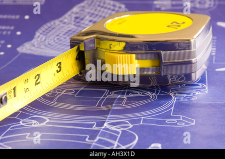 Tape measure on top of blueprints Stock Photo