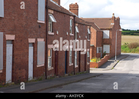 Depressed area with some terrace houses boarded up Stock Photo