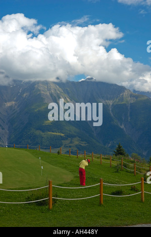 Playing golf in the swiss mountains Stock Photo