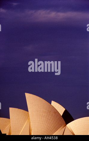Vertical image of Sydney Opera House showing deep blue purple sky with shells at the bottom of the frame Stock Photo