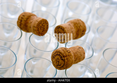 Champagne glasses laid out in geometric pattern with corks resting on top Stock Photo