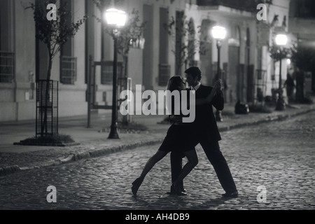 Couple dancing by lamplight on San Telmo street in Buenos Aires Stock Photo