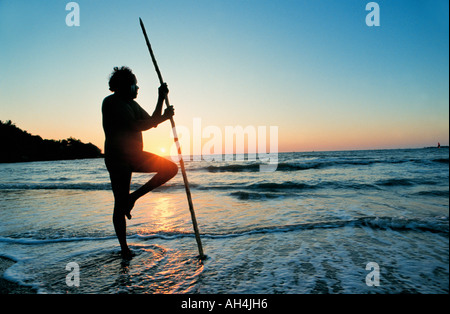 aboriginal with walking stick gazing at the sea, Darwin, Australia Stock Photo
