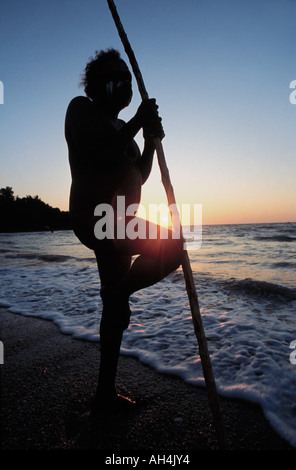 aboriginal with walking stick gazing at the sea, Darwin, Australia Stock Photo