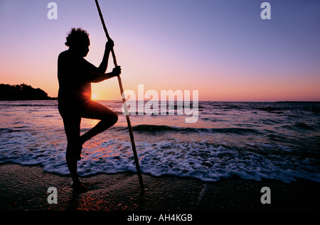 aboriginal with walking stick gazing at the sea, Darwin, Australia Stock Photo