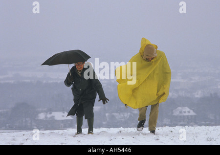 Ramblers Association UK seniors hiking in bad winter weather unprepared for stormy walking conditions Farthing Downs Surrey 1990s January 1991 Stock Photo