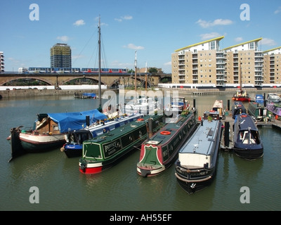 Limehouse Basin Grand Union Canal blocks of waterside apartments  narrowboat mooring london docklands light railway train Tower Hamlets East London UK Stock Photo